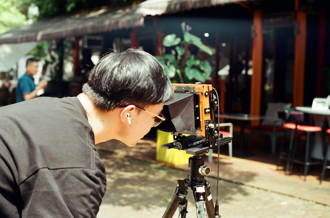 Camera operator filming a live report outdoors