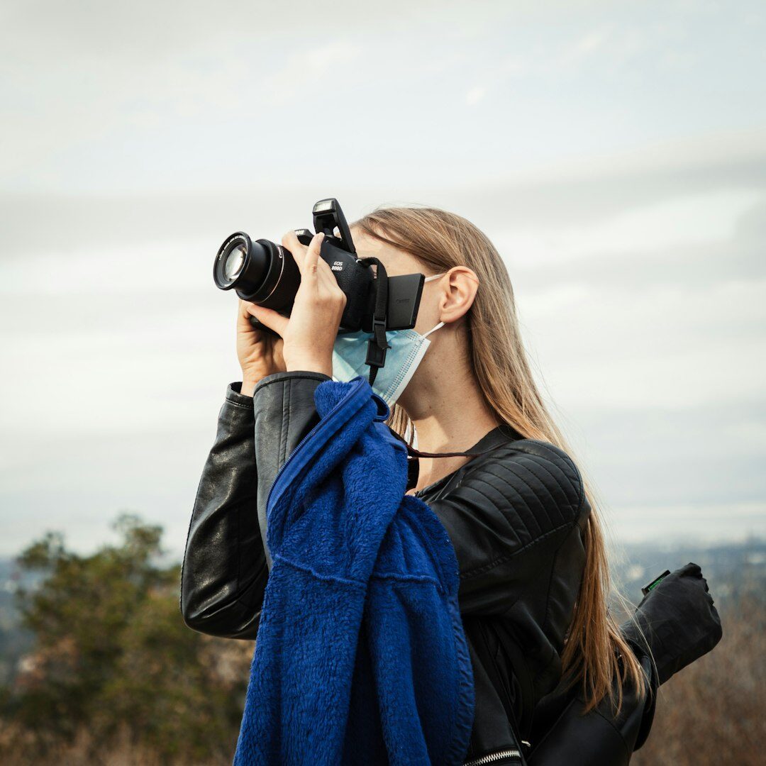 Journalist holding a video camera while reporting outdoors